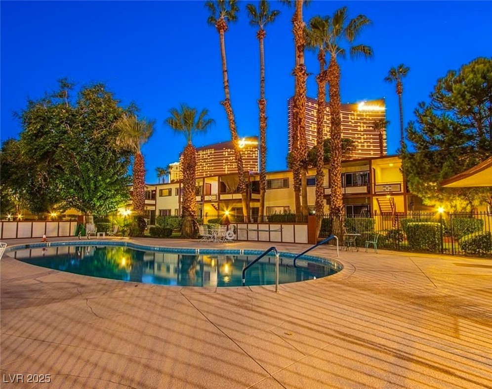 350 East Desert Inn Road, Unit C203 Las Vegas, NV 89109 - Photo 28 of 35 Pool at night with a community pool and a patio