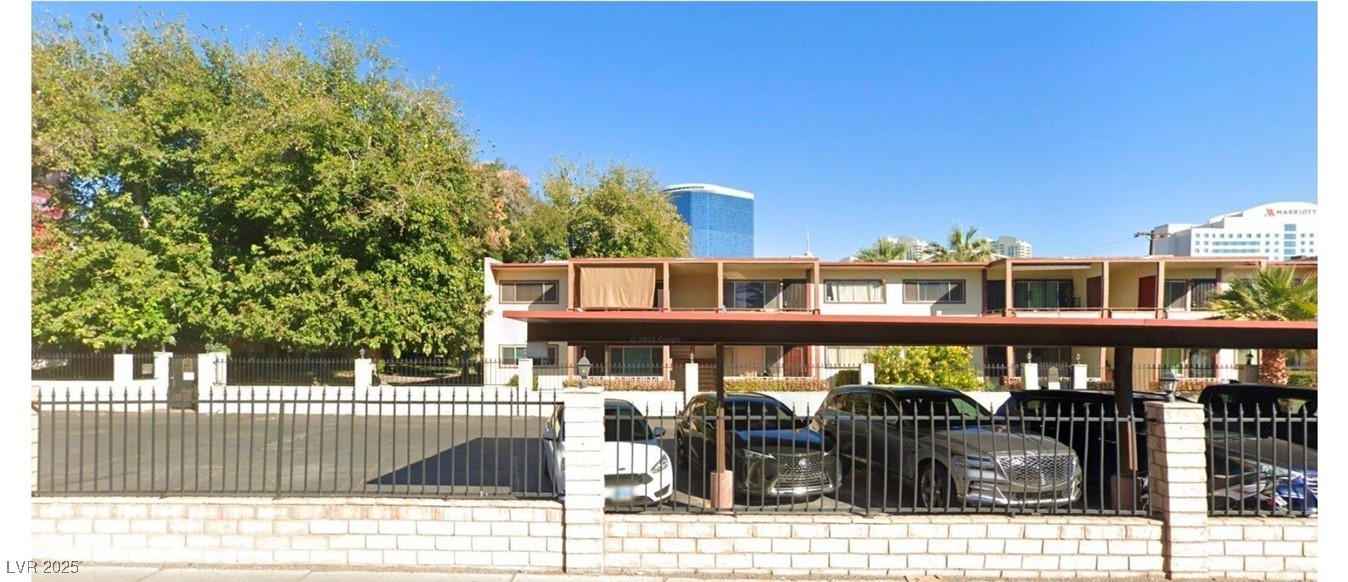 350 East Desert Inn Road, Unit C203 Las Vegas, NV 89109 - Photo 34 of 35 View of front of house with a fenced front yard and covered parking