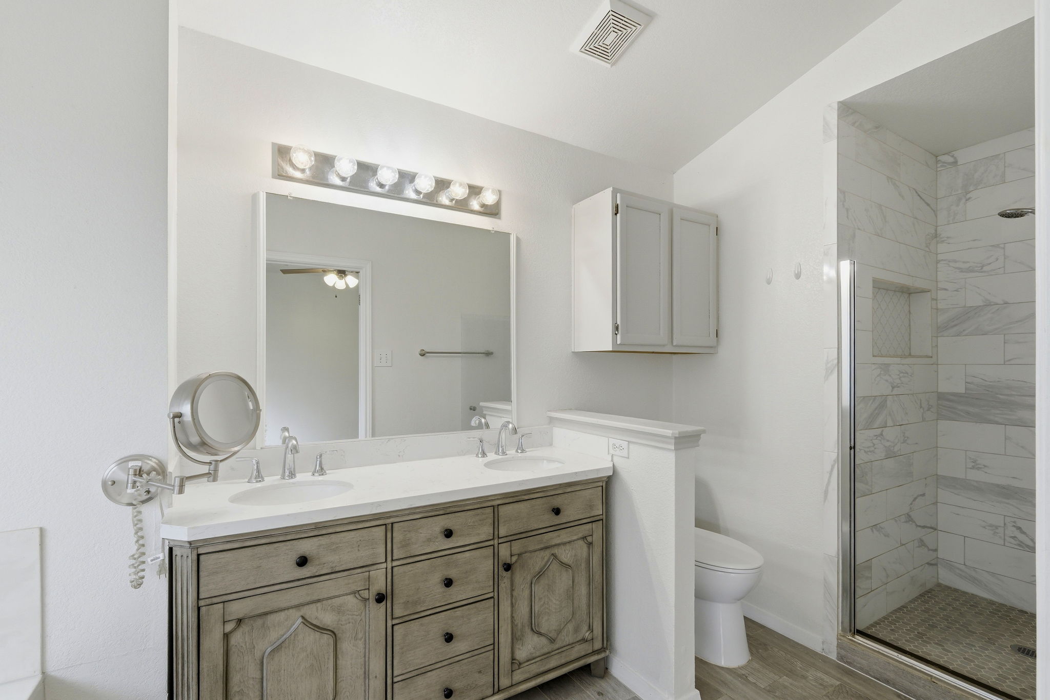1005 Rolling Ridge Drive Round Rock, TX 78665 - Photo 7 of 18 A pristine primary bathroom featuring a double vanity with ample storage and a spacious walk-in shower.