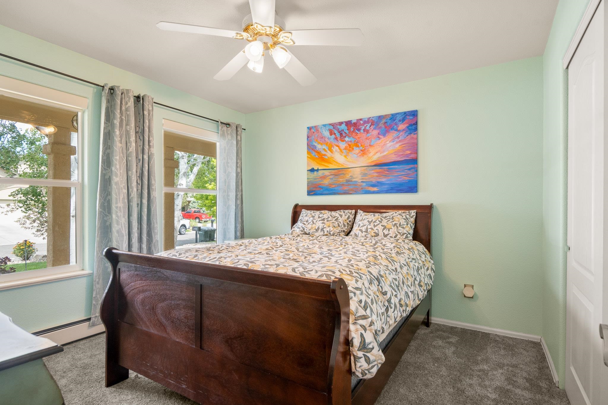 398 Butte Court Grand Junction, CO 81507 - Photo 15 of 33 a bedroom with a bed and a painting on the wall