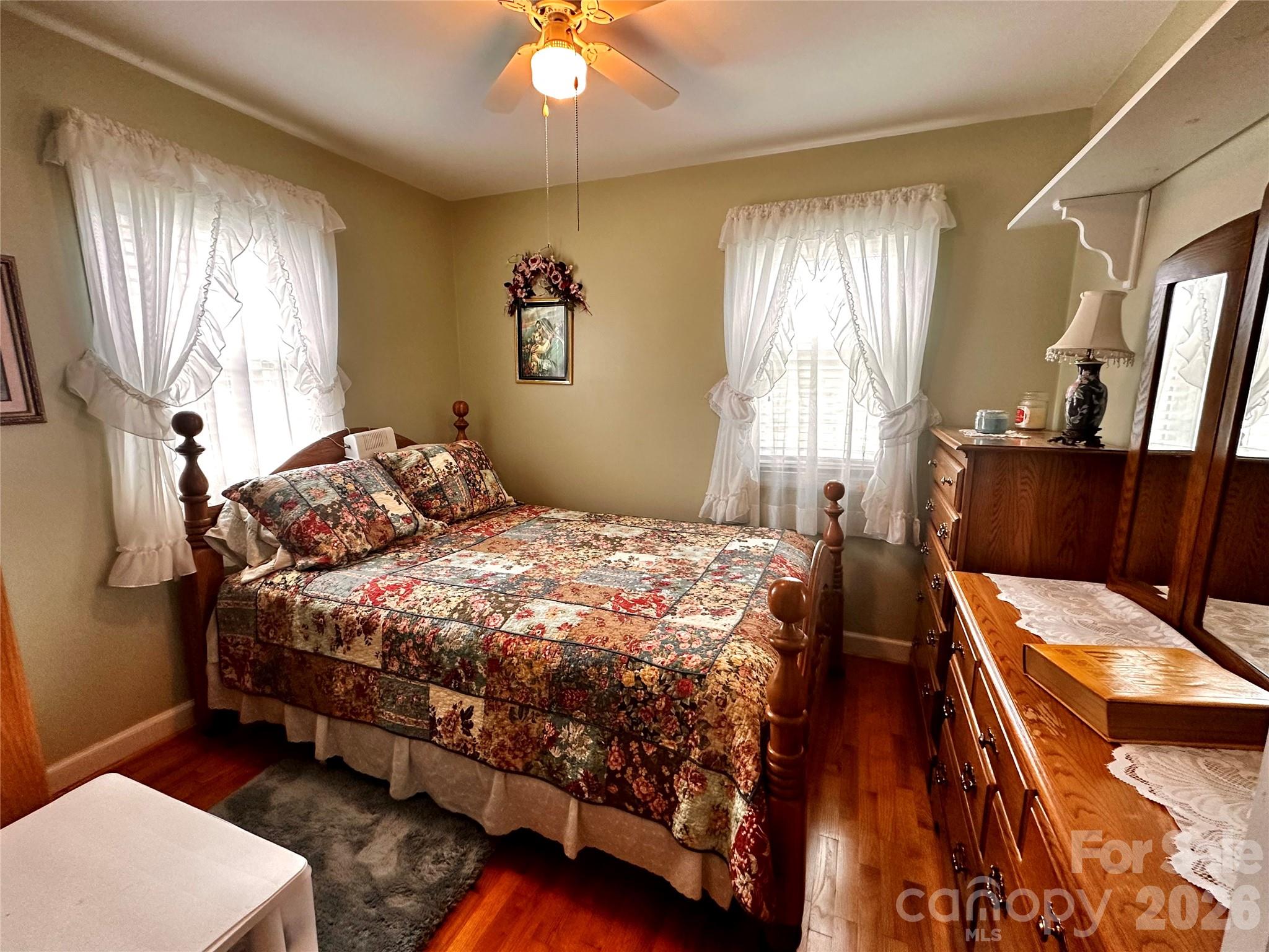 580 Russ Norris Heaton Road Elk Park, NC 28622 - Photo 15 of 42 a bedroom with a bed and a chandelier