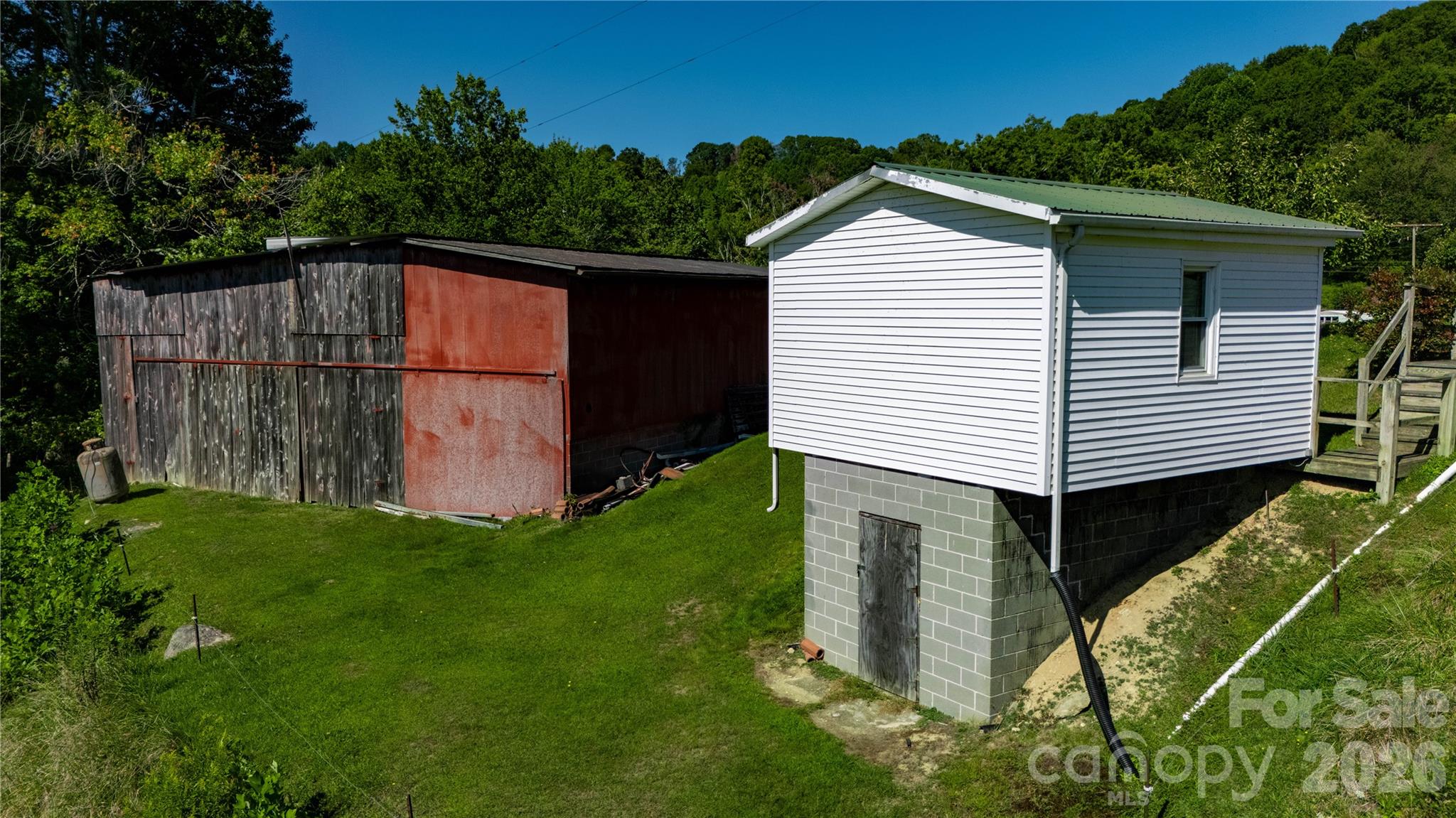 580 Russ Norris Heaton Road Elk Park, NC 28622 - Photo 20 of 42 a front view of a house with a yard