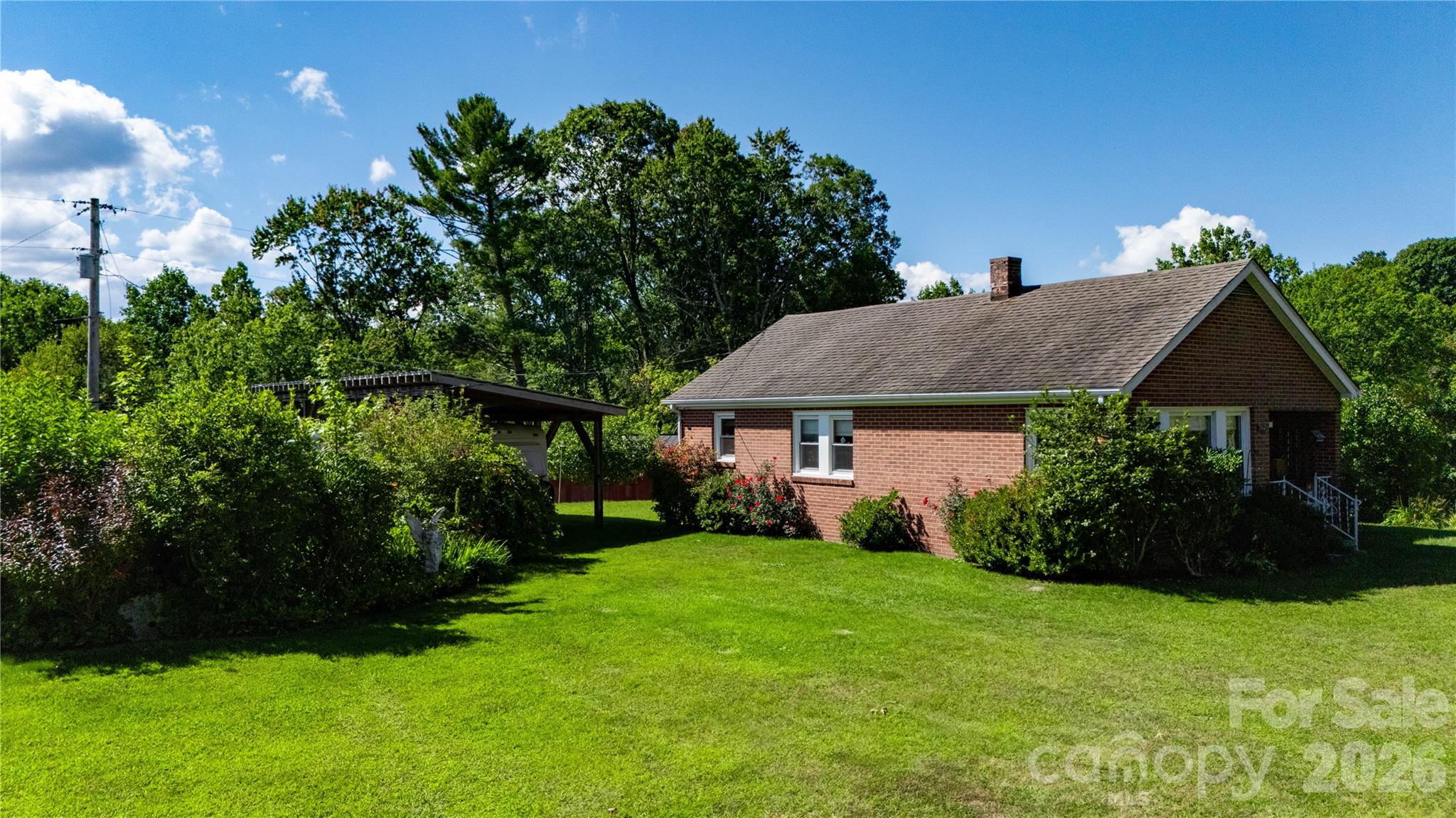 580 Russ Norris Heaton Road Elk Park, NC 28622 - Photo 21 of 42 a view of a house with garden and yard