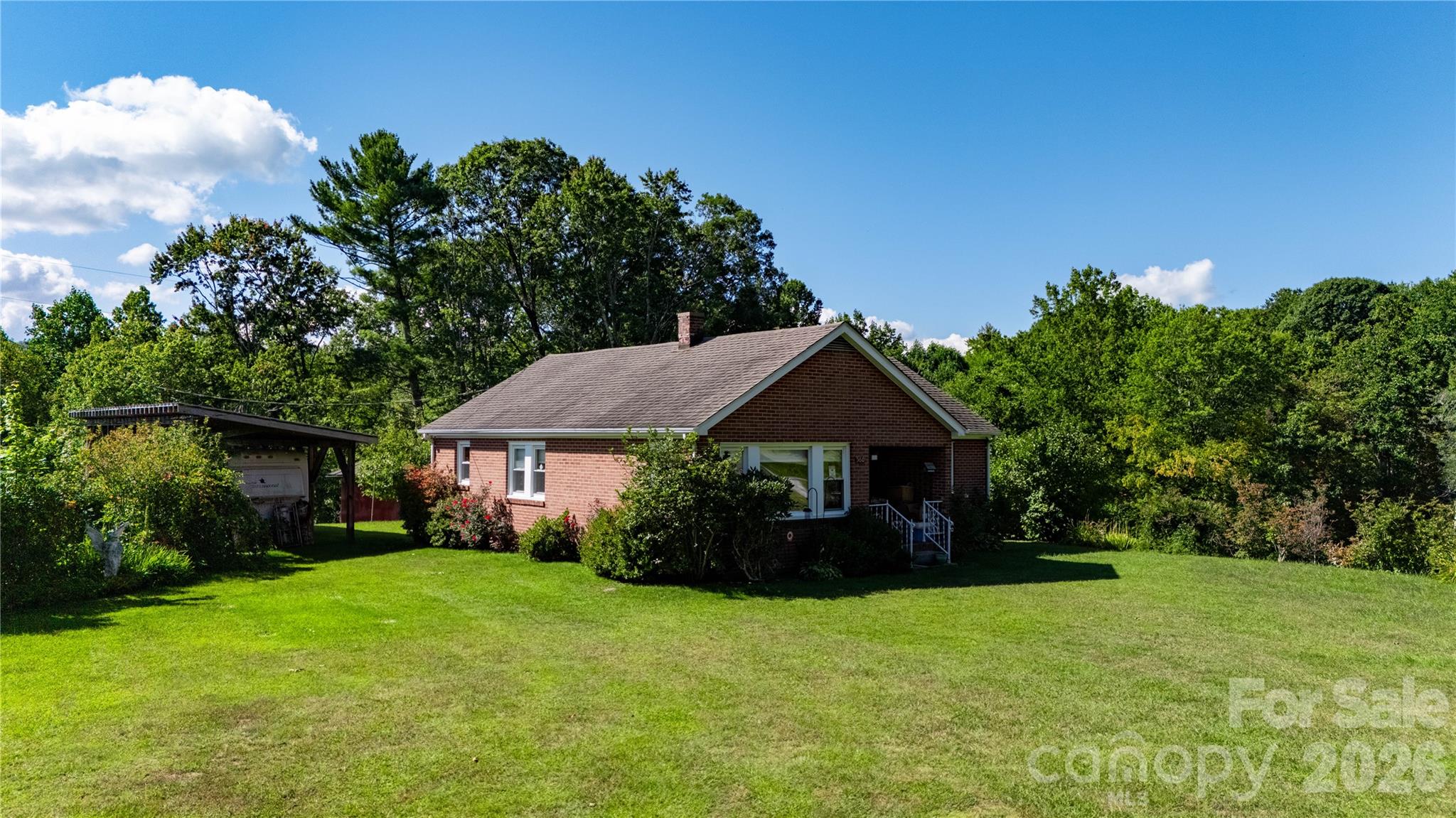 580 Russ Norris Heaton Road Elk Park, NC 28622 - Photo 36 of 42 a front view of a house with garden