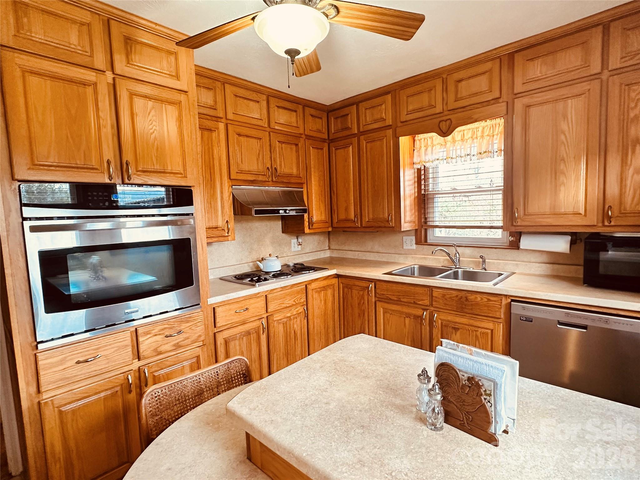 580 Russ Norris Heaton Road Elk Park, NC 28622 - Photo 7 of 42 a kitchen with stainless steel appliances granite countertop a sink a stove and cabinets