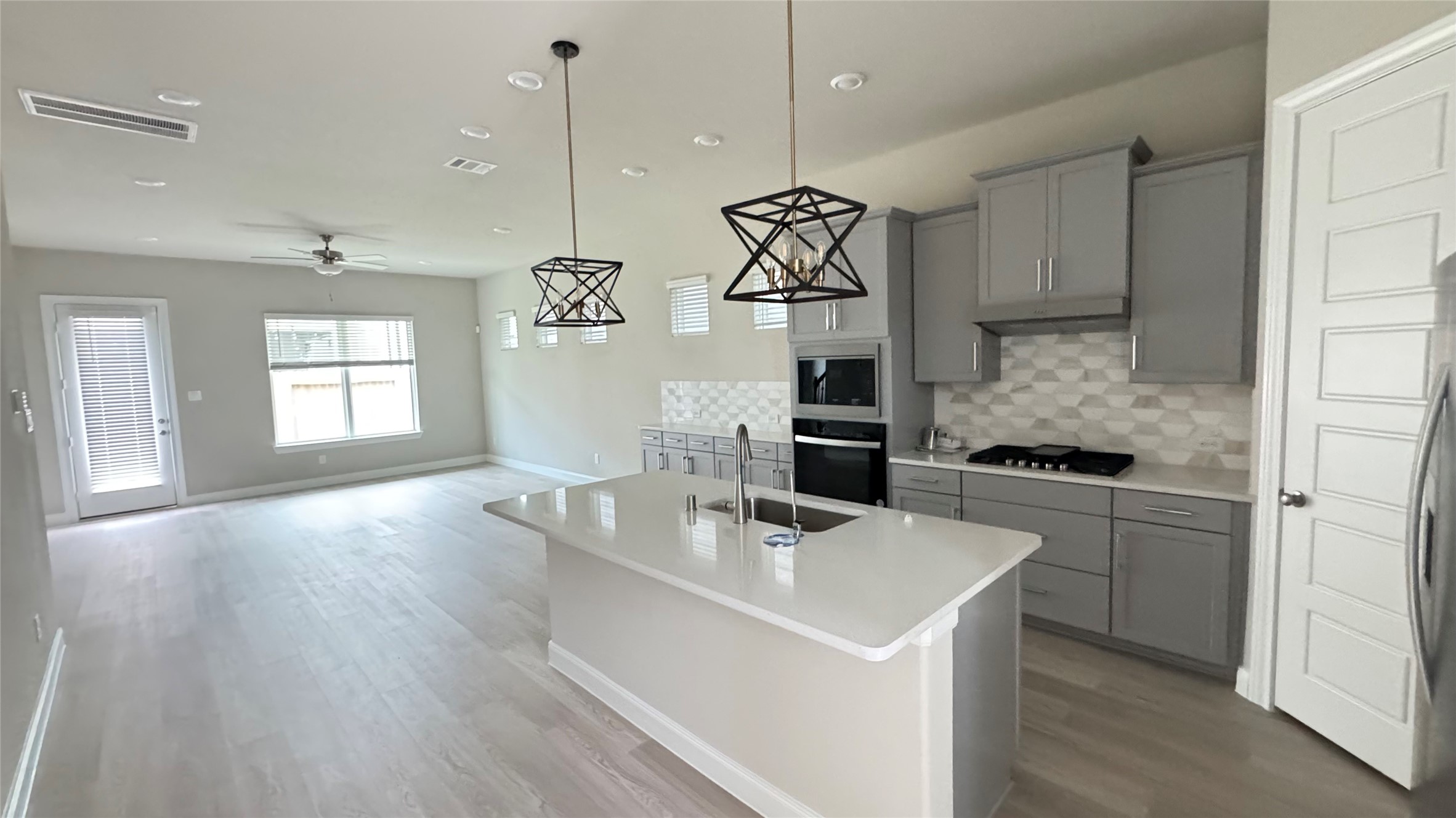 3005 Manor Heights Lane Houston, TX 77063 - Photo 1 of 35 a kitchen with a sink a stove a refrigerator and chandelier