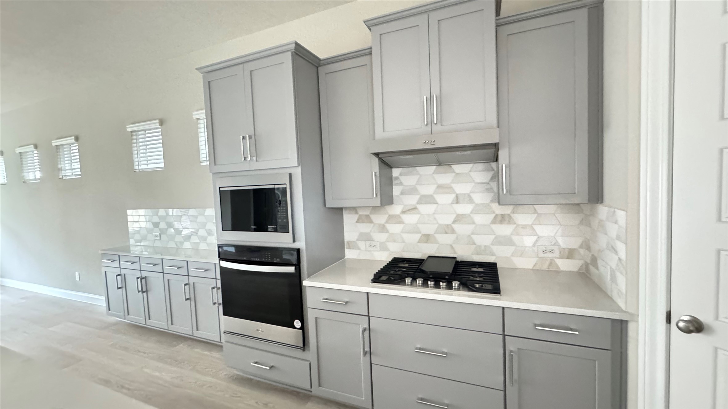 3005 Manor Heights Lane Houston, TX 77063 - Photo 12 of 35 a kitchen with white cabinets and appliances