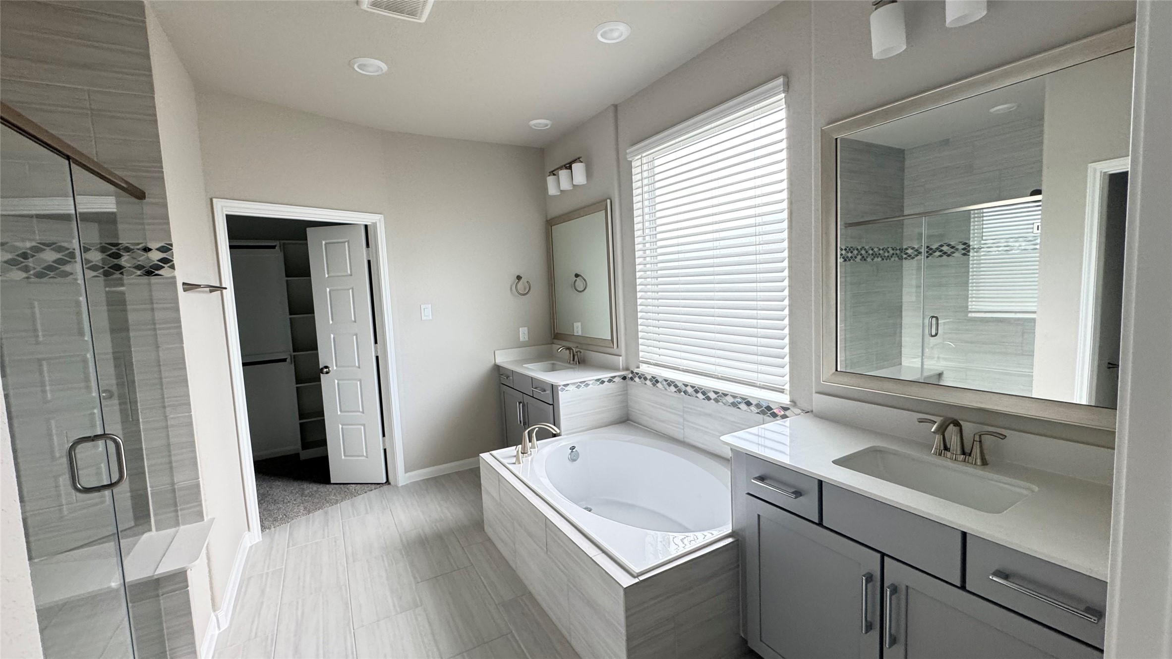3005 Manor Heights Lane Houston, TX 77063 - Photo 20 of 35 a bathroom with a granite countertop sink a mirror and a shower