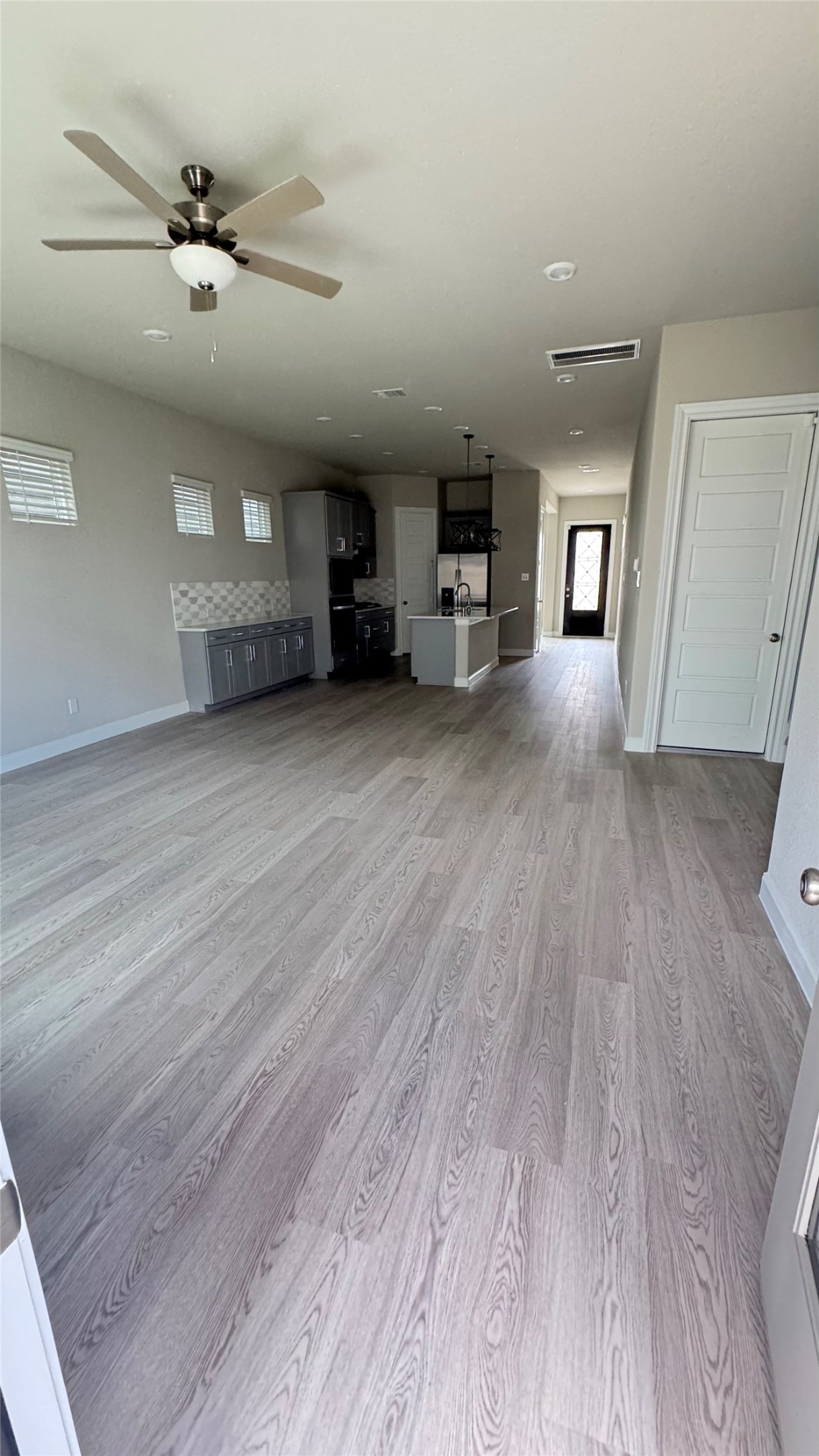 3005 Manor Heights Lane Houston, TX 77063 - Photo 5 of 35 a view of a livingroom with a hardwood floor and a ceiling fan