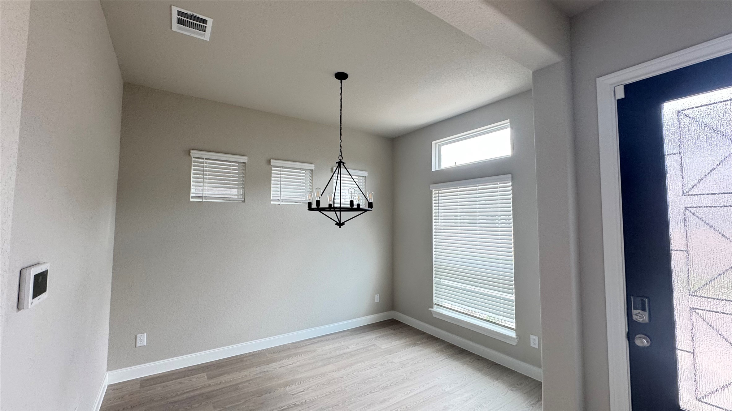 3005 Manor Heights Lane Houston, TX 77063 - Photo 8 of 35 a view of empty room with window and chandelier fan