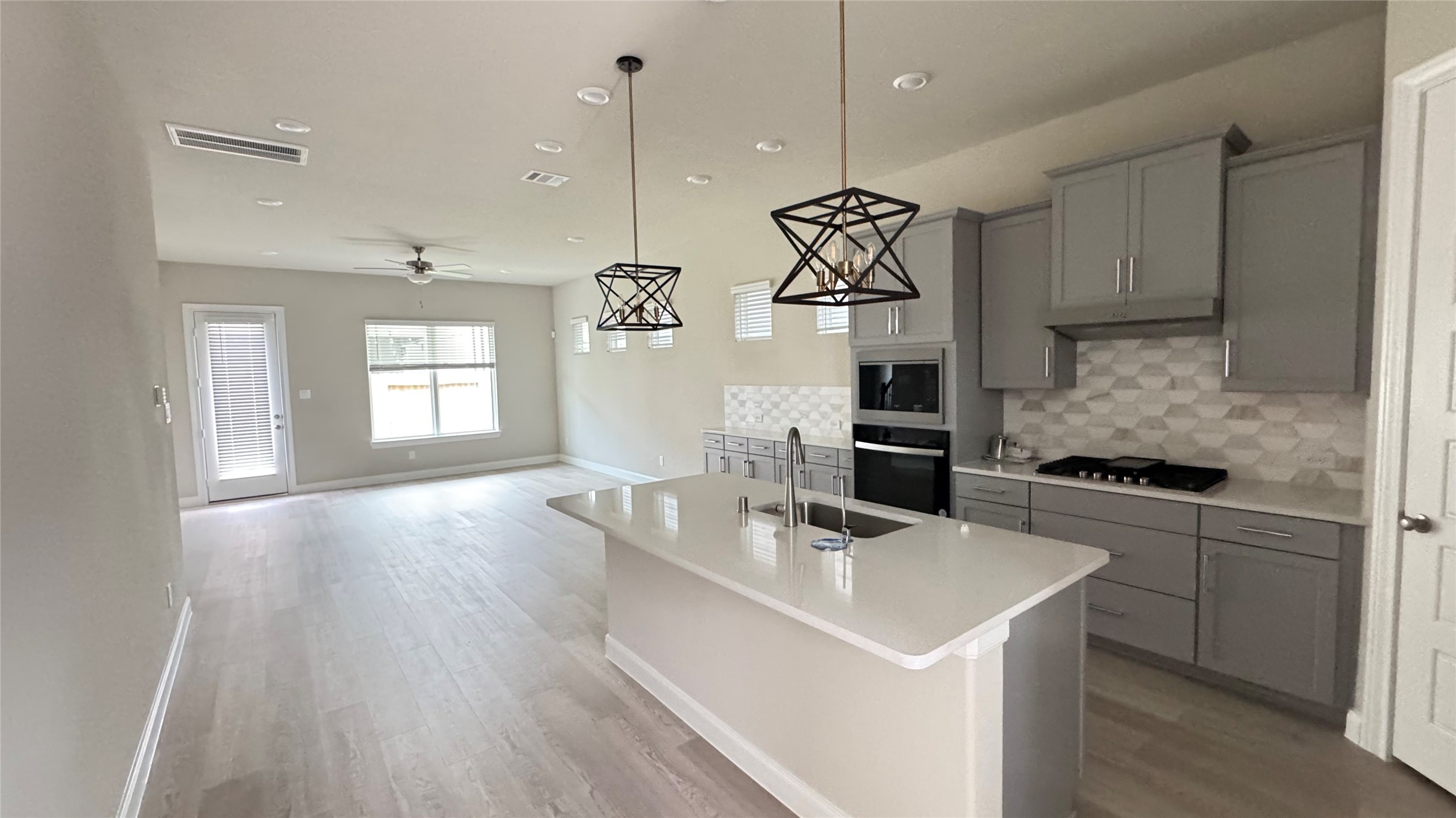 3005 Manor Heights Lane Houston, TX 77063 - Photo 10 of 35 a kitchen with a sink a stove a refrigerator and windows