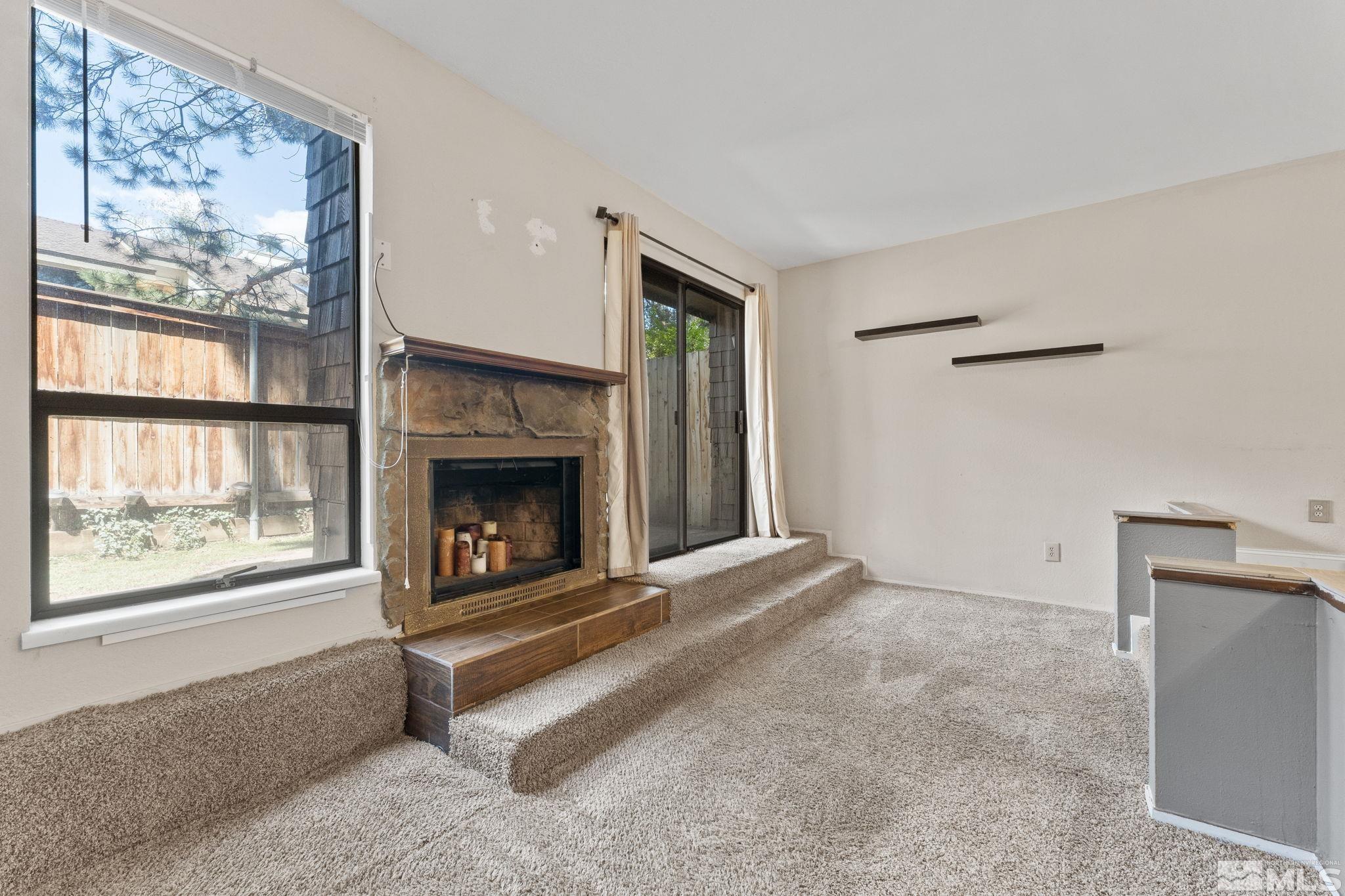 4185 Baker Lane Reno, NV 89509 - Photo 13 of 29 a living room with a fireplace and a large window
