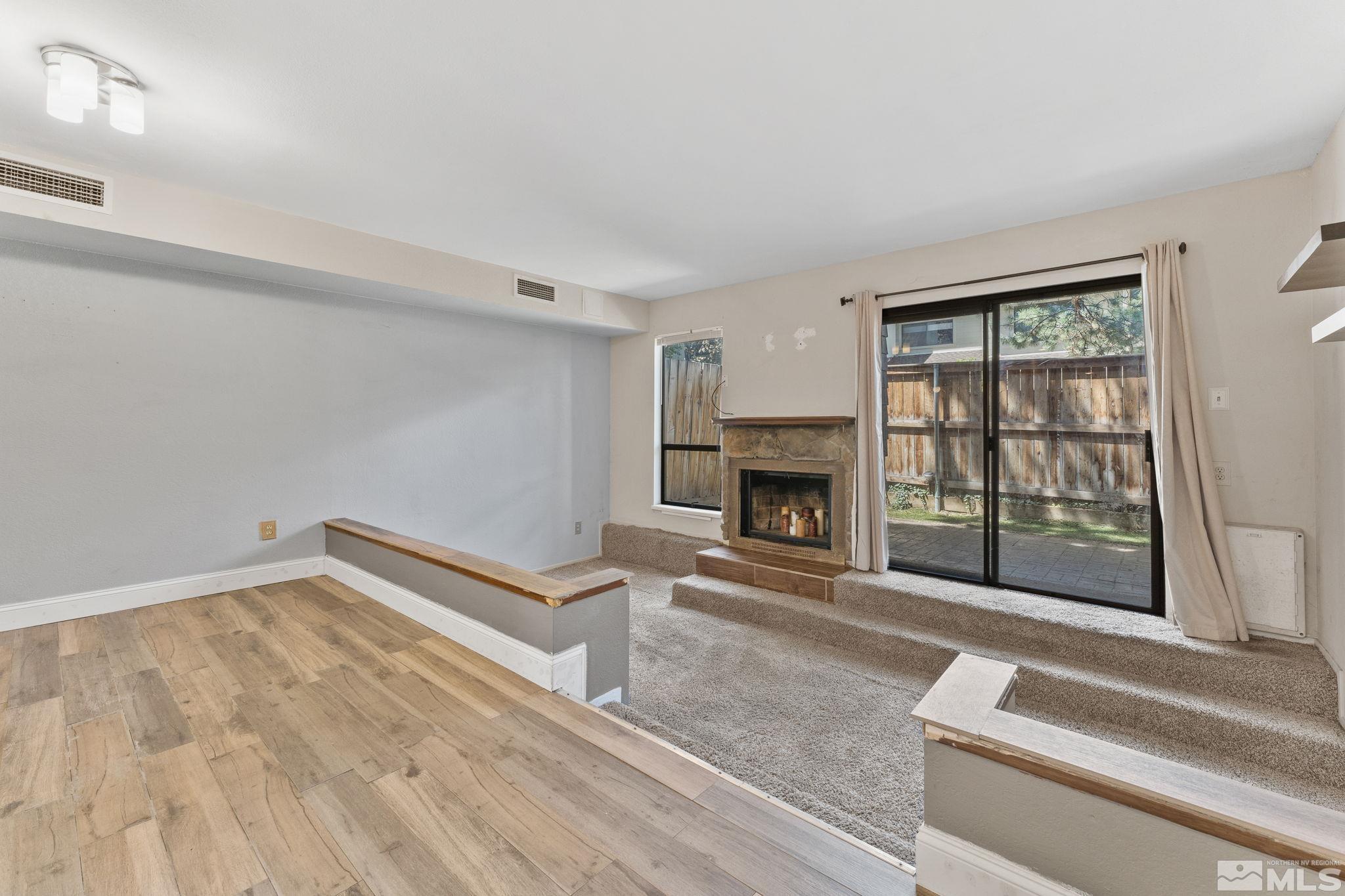4185 Baker Lane Reno, NV 89509 - Photo 15 of 29 a living room with a fireplace furniture and a floor to ceiling window