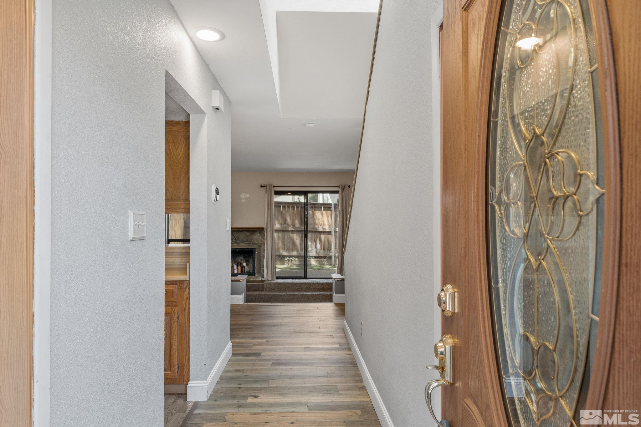 4185 Baker Lane Reno, NV 89509 - Photo 2 of 29 a view of a hallway with wooden floor and staircase