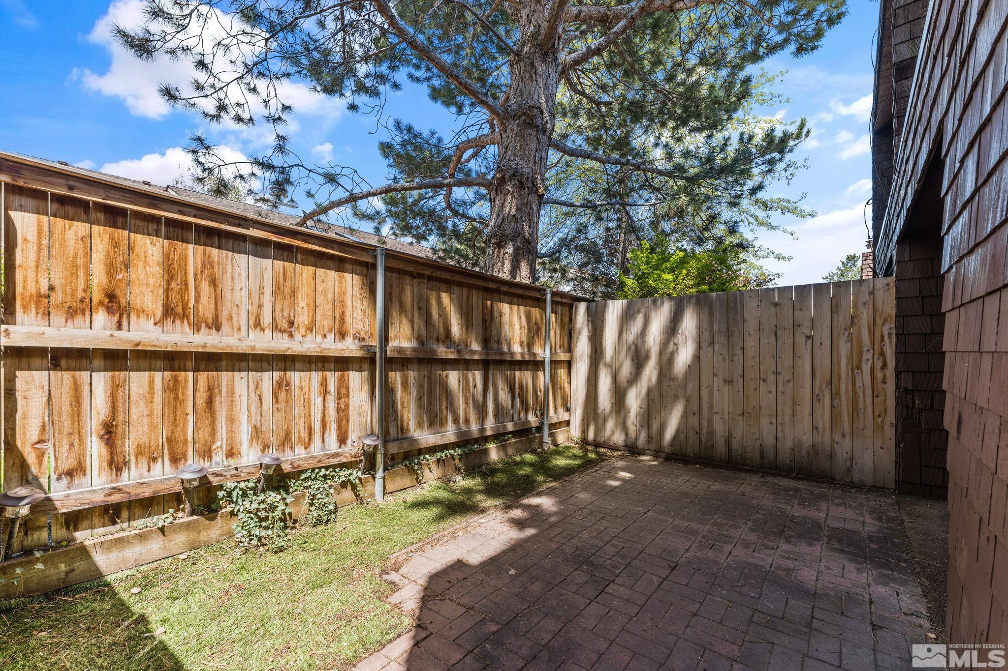 4185 Baker Lane Reno, NV 89509 - Photo 27 of 29 a view of backyard with wooden fence and large trees