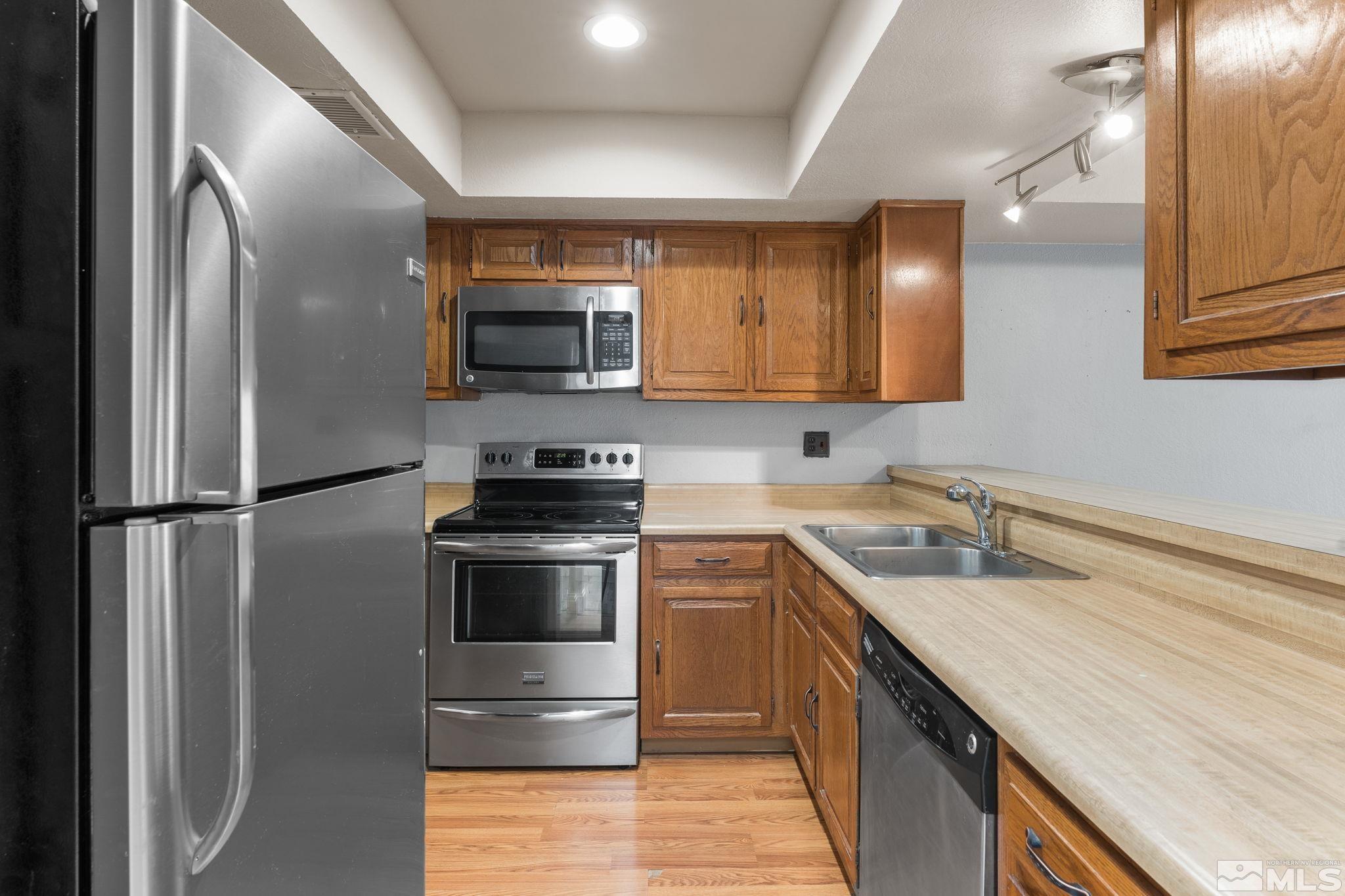 4185 Baker Lane Reno, NV 89509 - Photo 6 of 29 a kitchen with a sink and stainless steel appliances
