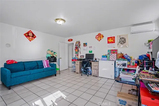 a view of play room with toys and a flat screen tv