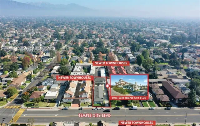 an aerial view of residential houses with outdoor space