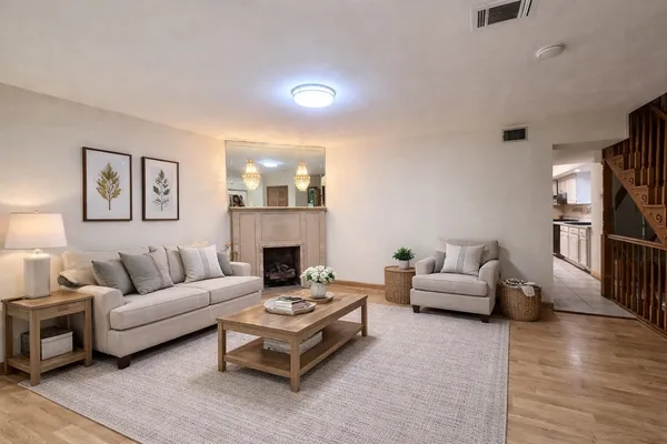a living room with furniture and a fireplace