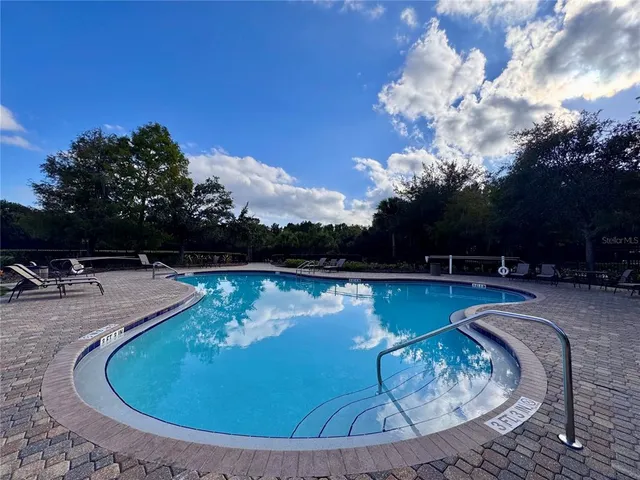 a view of a house with backyard and sitting area