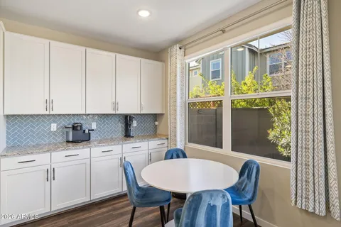a kitchen with a table chairs and cabinets
