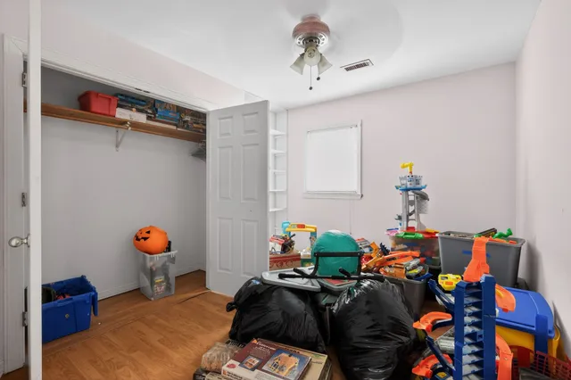 a bedroom with furniture and a book shelf
