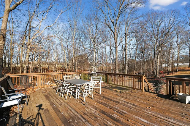 a view of a patio with table and chairs and wooden floor