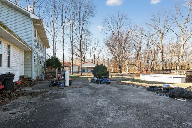 a view of a house with backyard and a tree
