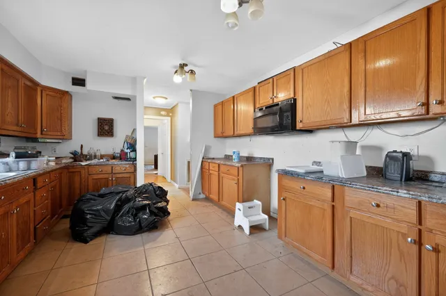 a kitchen with stainless steel appliances granite countertop a stove sink and cabinets