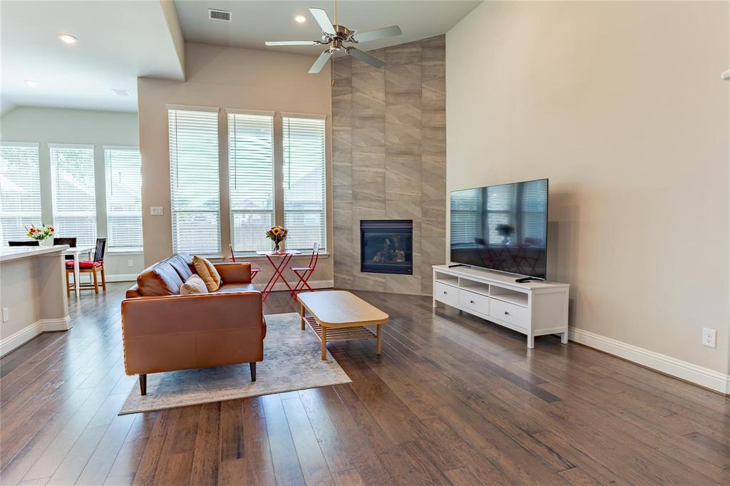 3920 Bentgrass Road Plano, TX 75023 - Photo 9 of 30 a living room with furniture fireplace and flat screen tv