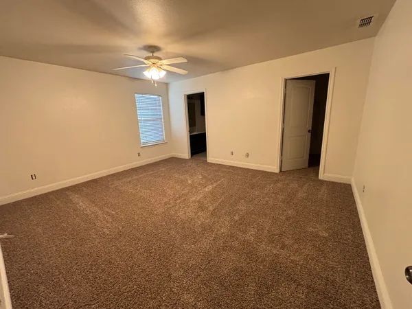a view of a room with a ceiling fan