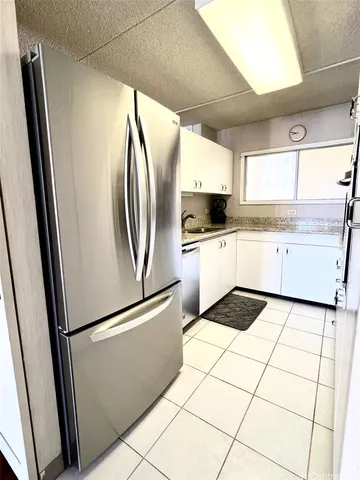 a kitchen with granite countertop a sink and a stove