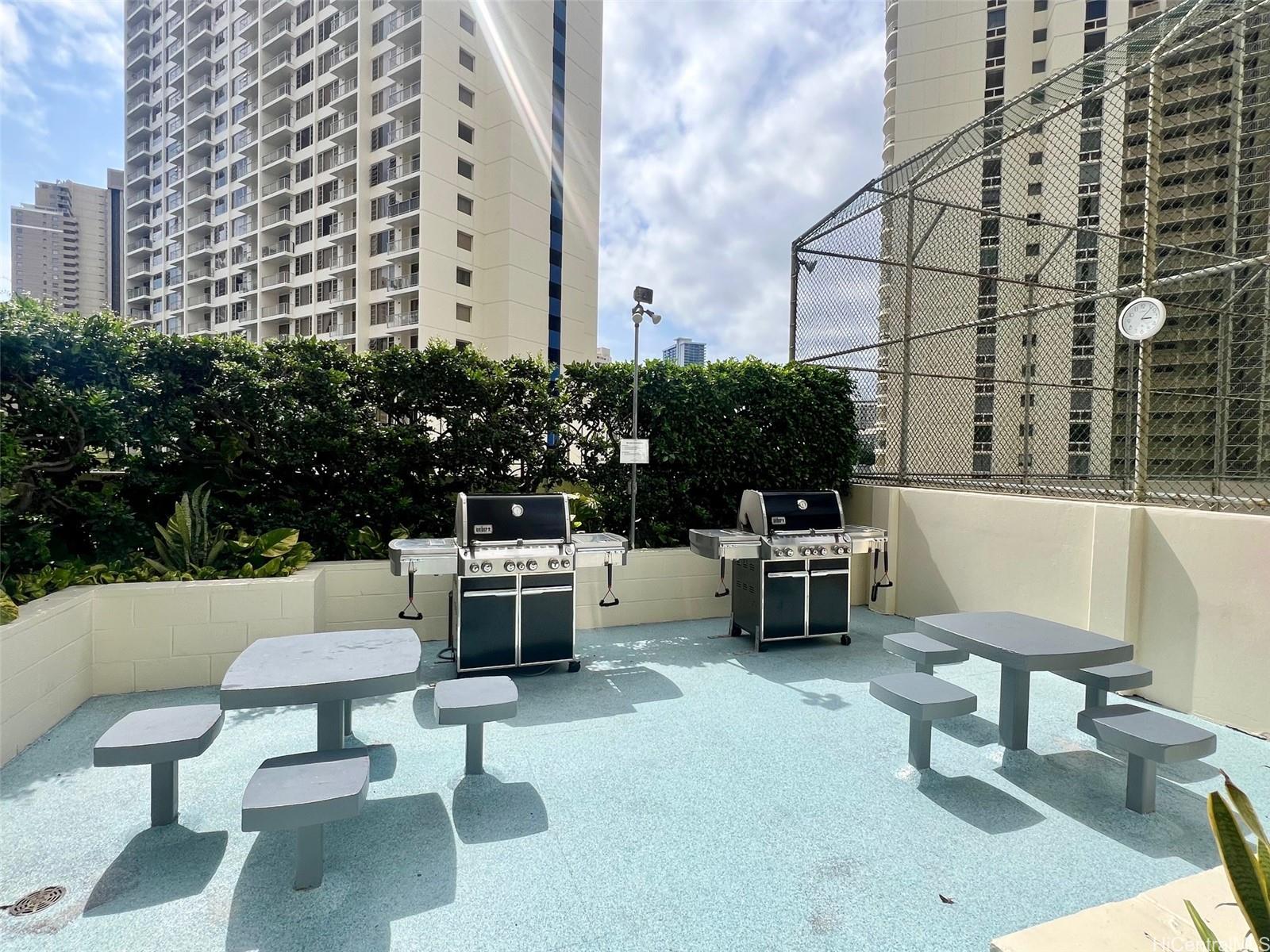 469 Ena Road, Unit 2010 Honolulu, HI 96815 - Photo 19 of 25 a building outdoor space with patio furniture and potted plants