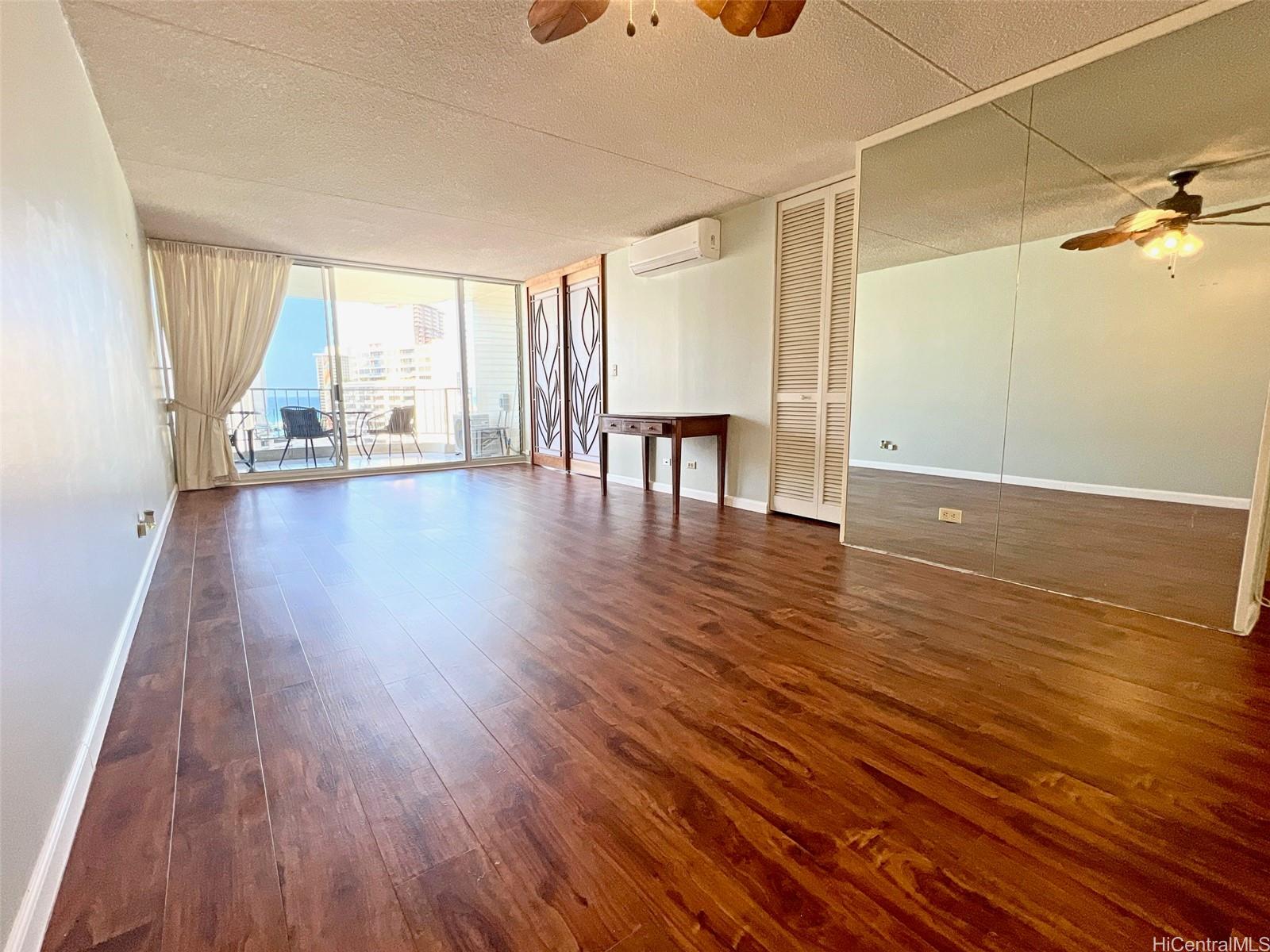 469 Ena Road, Unit 2010 Honolulu, HI 96815 - Photo 5 of 25 a view of empty room with wooden floor and fan