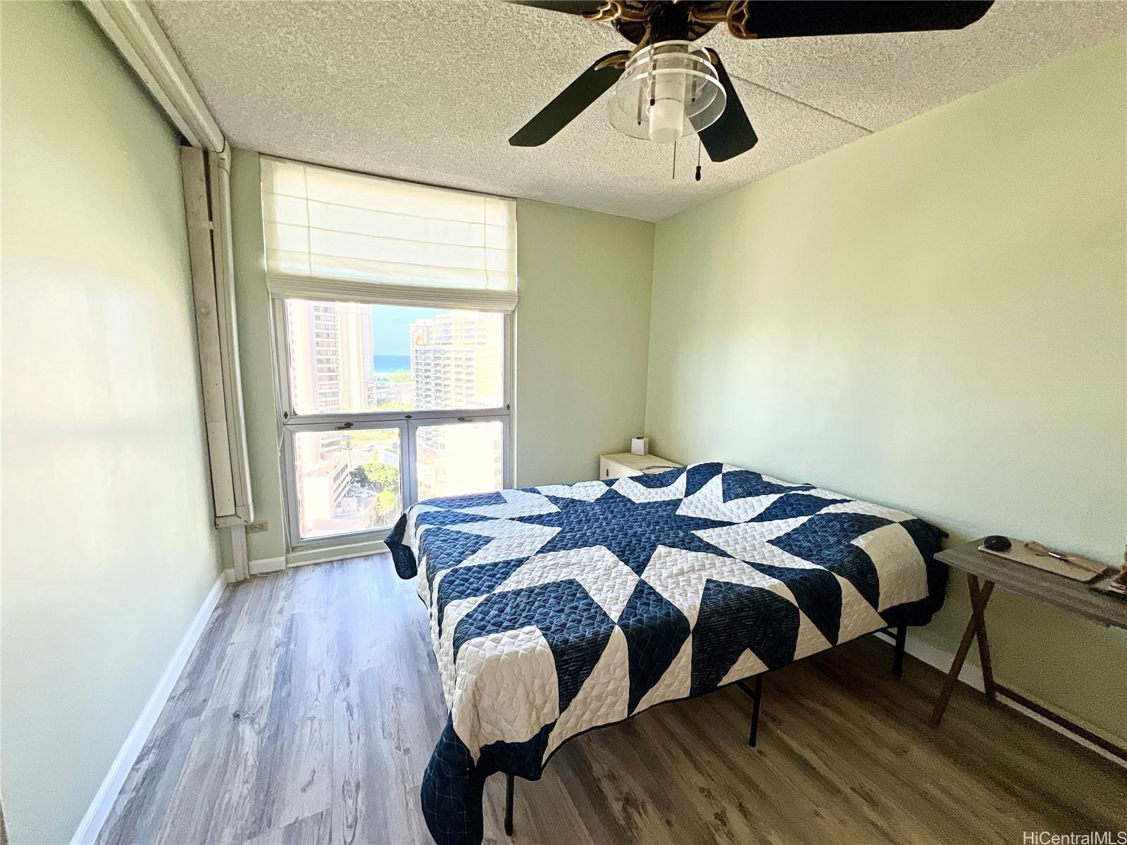 469 Ena Road, Unit 2010 Honolulu, HI 96815 - Photo 8 of 25 a bedroom with a bed and a window