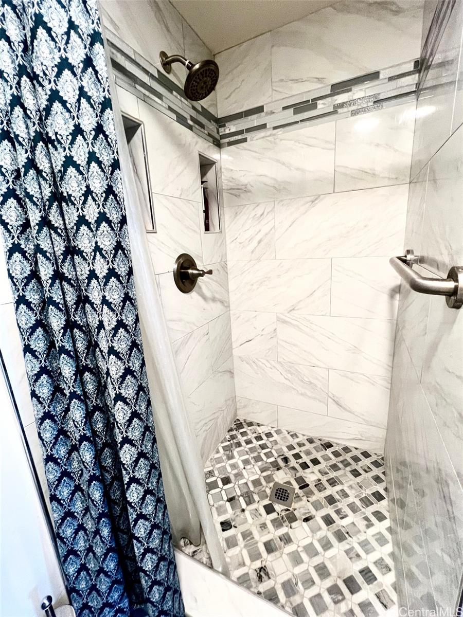 469 Ena Road, Unit 2010 Honolulu, HI 96815 - Photo 10 of 25 a bathroom with a shower and a toilet