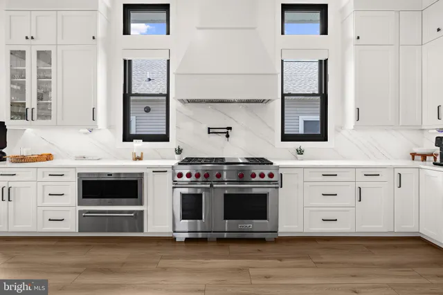 a kitchen with stainless steel appliances granite countertop a stove and a sink