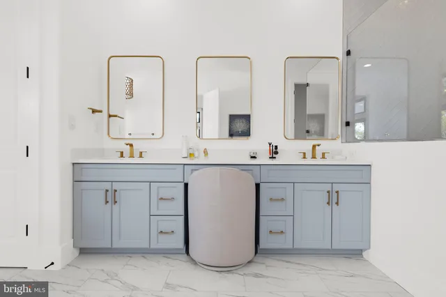 a bathroom with a sink vanity and mirror