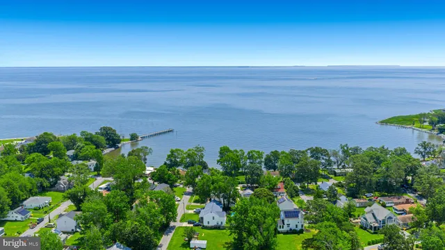 an aerial view of residential houses with outdoor space and swimming pool
