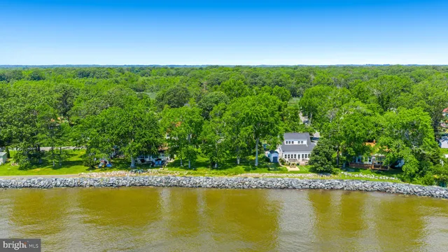 an aerial view of residential houses with outdoor space and swimming pool
