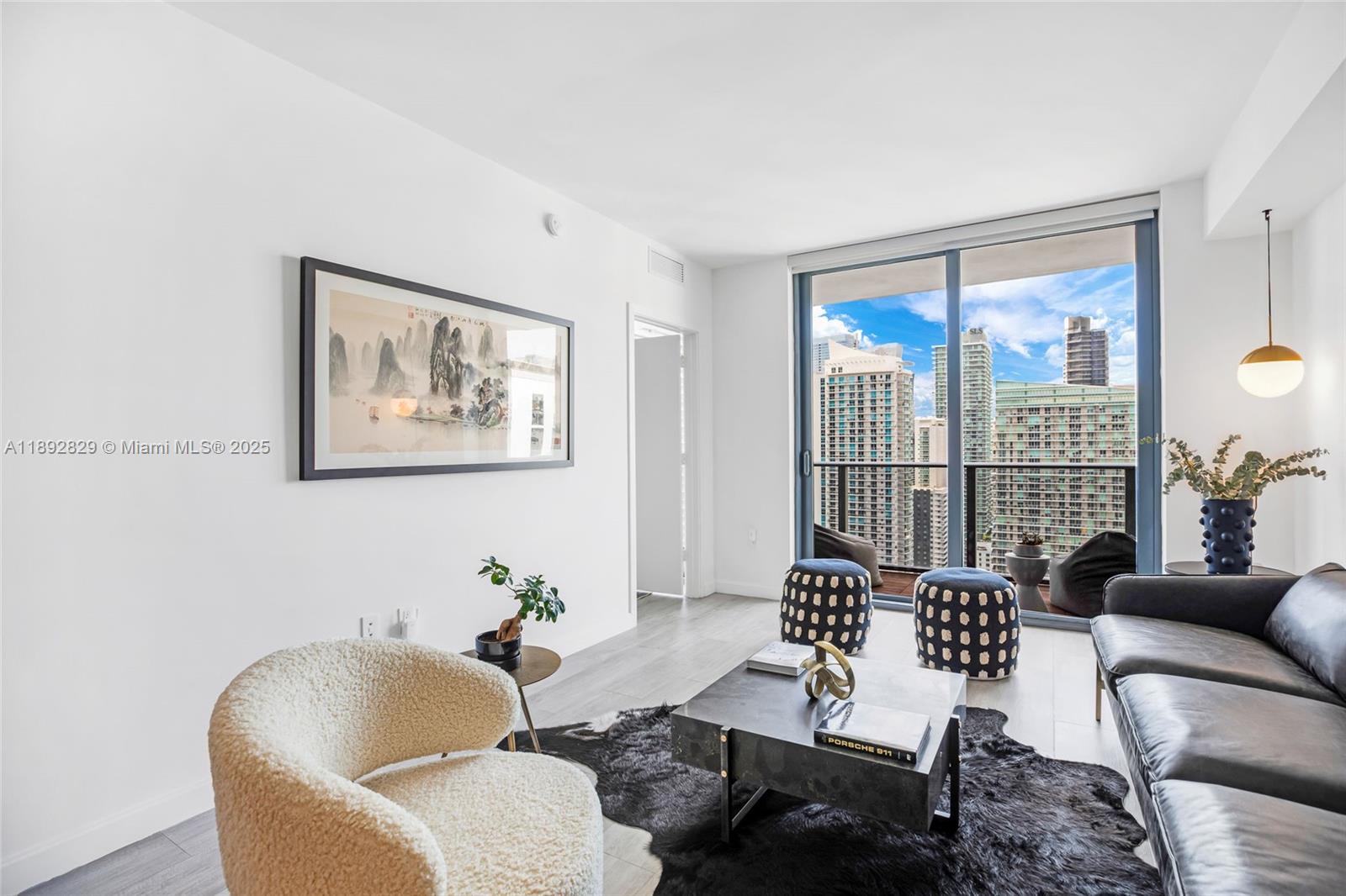55 Southwest 9th Street, Unit 3205 Miami, FL 33130 - Photo 14 of 39 a living room with furniture and a large window