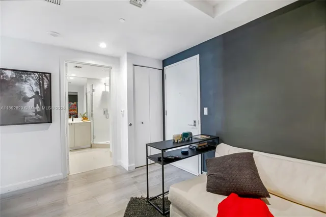 a living room with furniture and wall paintings