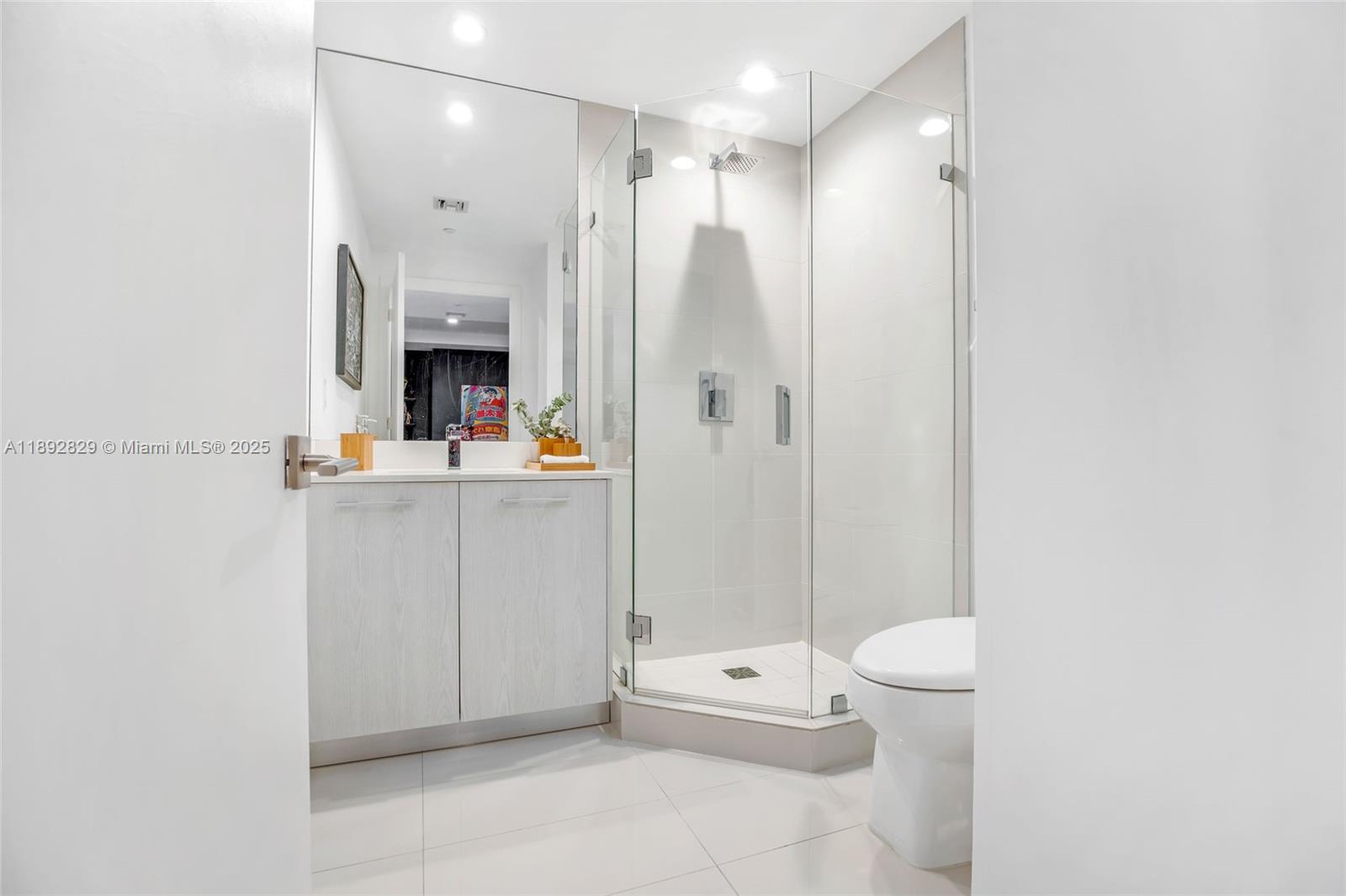 55 Southwest 9th Street, Unit 3205 Miami, FL 33130 - Photo 21 of 39 a bathroom with a sink a toilet and shower