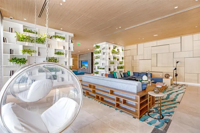 a dining room with furniture and a floor to ceiling window