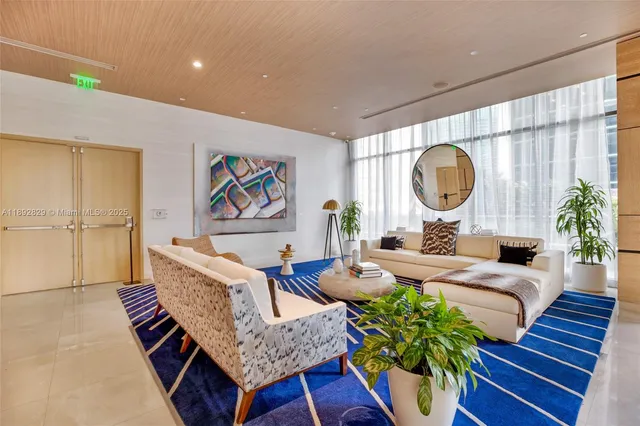 a bedroom with furniture and a large window