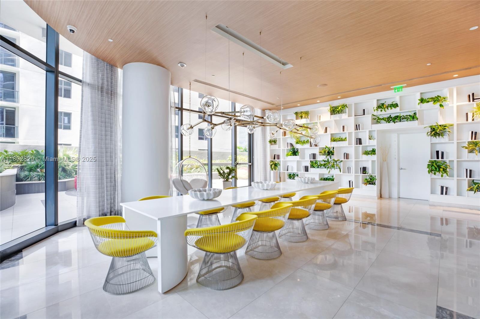 55 Southwest 9th Street, Unit 3205 Miami, FL 33130 - Photo 32 of 39 a room with lots of white furniture and a large window