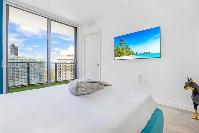 a view of a bedroom with a bed and glass door