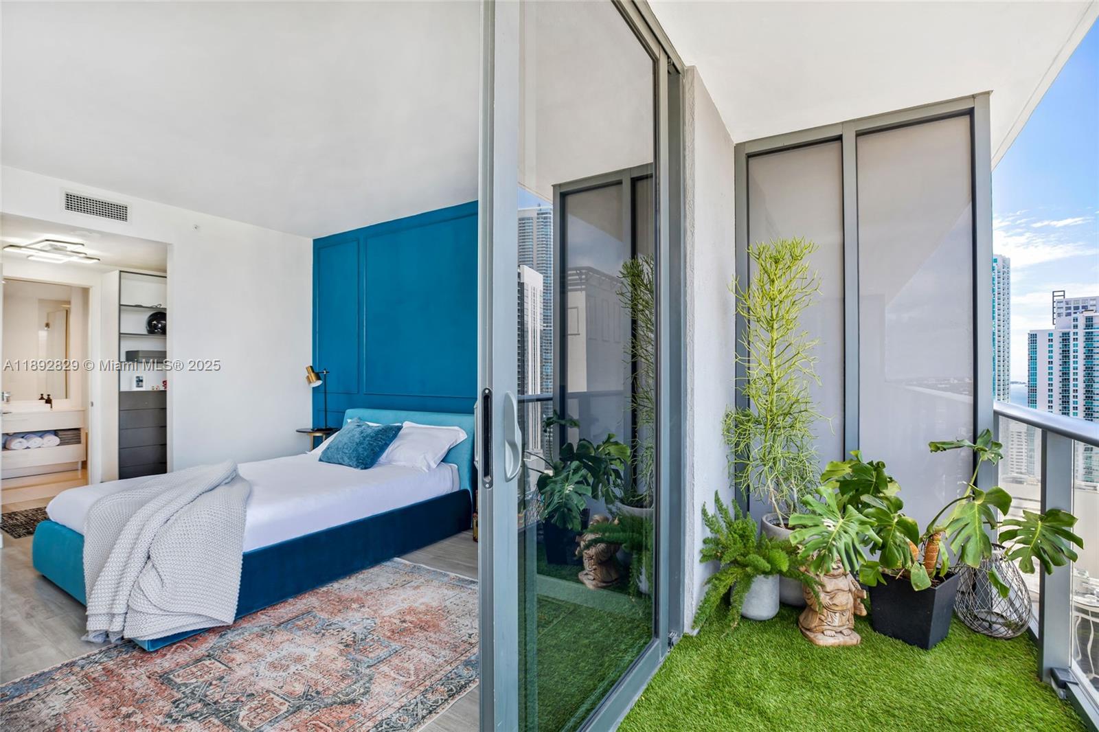 55 Southwest 9th Street, Unit 3205 Miami, FL 33130 - Photo 8 of 39 a bedroom with a bed potted plant and windows