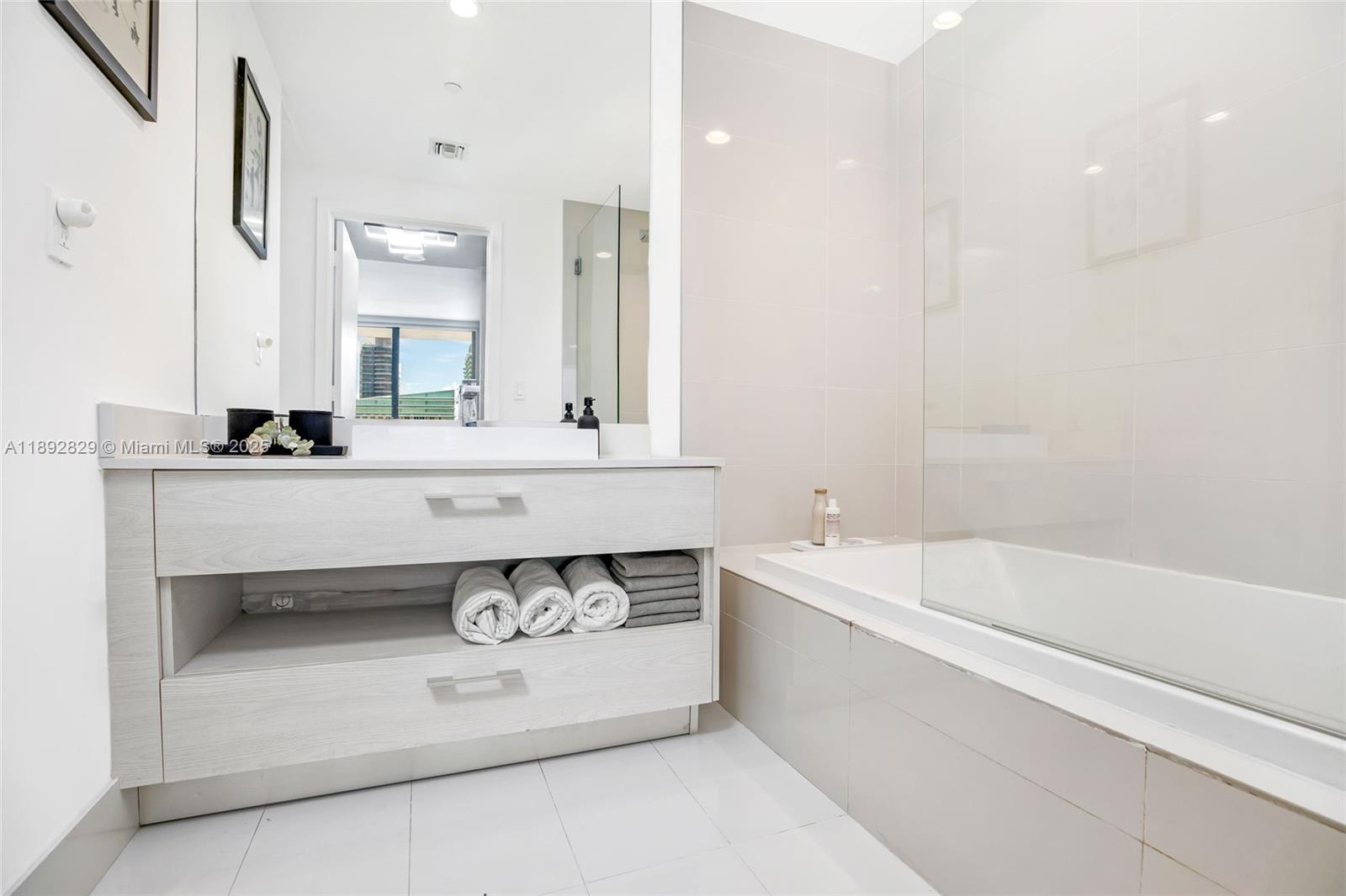 55 Southwest 9th Street, Unit 3205 Miami, FL 33130 - Photo 10 of 39 a bathroom with a bathtub and a sink