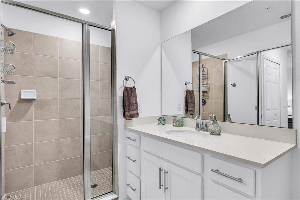 43989 Boardwalk Loop, Unit 2032 Punta Gorda, FL 33982 - Photo 12 of 14 a bathroom with a shower sink and mirror